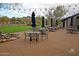Picturesque outdoor patio with seating, umbrellas, string lights and manicured lawn with mountain views at 20704 N 90Th Pl # 1015, Scottsdale, AZ 85255