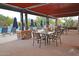 Inviting outdoor seating near a pool with comfortable loungers and shaded tables with umbrellas at 20704 N 90Th Pl # 1015, Scottsdale, AZ 85255