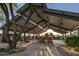 Community playground under a shaded pavilion, complete with rocking chairs and mature trees at 20704 N 90Th Pl # 1015, Scottsdale, AZ 85255