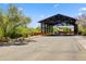 Street view showing road to restaurant and shops under steel beam overhang at 20704 N 90Th Pl # 1015, Scottsdale, AZ 85255