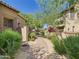 Paver walkway between tan stucco homes with desert landscaping at 20704 N 90Th Pl # 1015, Scottsdale, AZ 85255
