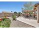 Charming backyard featuring a covered patio, desert landscaping, and ample space for outdoor dining and relaxation at 20739 N 106Th Ln, Peoria, AZ 85382