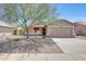 Charming single-story home featuring a low-maintenance desert landscape and a covered entrance at 20739 N 106Th Ln, Peoria, AZ 85382