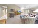 Spacious living room with neutral carpet, vaulted ceilings, and sliding doors to the backyard at 20739 N 106Th Ln, Peoria, AZ 85382
