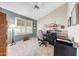Functional home office space with large windows, natural light, and tiled flooring at 20739 N 106Th Ln, Peoria, AZ 85382