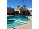 Community pool and jacuzzi with clubhouse in a residential neighborhood at 20739 N 106Th Ln, Peoria, AZ 85382