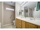 Spacious bathroom featuring double sinks, tile flooring, and well-lit vanity mirrors at 22333 E Calle De Flores St, Queen Creek, AZ 85142