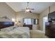 The main bedroom with ceiling fan features vaulted ceilings and a beautiful wooden dresser at 22333 E Calle De Flores St, Queen Creek, AZ 85142