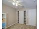 Cozy bedroom with neutral walls, ceiling fan, plush carpet and closet at 22333 E Calle De Flores St, Queen Creek, AZ 85142