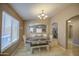 A beautiful dining room offers an open view and features a wooden table with six chairs at 22333 E Calle De Flores St, Queen Creek, AZ 85142