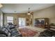 Comfortable living room featuring leather furniture, a ceiling fan, and a sliding glass door at 22333 E Calle De Flores St, Queen Creek, AZ 85142