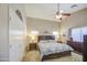 Spacious bedroom featuring a ceiling fan, a king-sized bed, and neutral-toned walls at 22333 E Calle De Flores St, Queen Creek, AZ 85142
