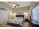Cozy bedroom featuring a king-sized bed, neutral walls, and soft, natural lighting at 22333 E Calle De Flores St, Queen Creek, AZ 85142
