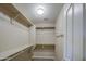 Walk-in closet with neutral walls, carpeted flooring, and multiple shelves for organization at 22333 E Calle De Flores St, Queen Creek, AZ 85142