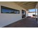 Back patio with neutral colored brick, a sliding glass door, and partial views of the backyard at 228 E Del Rio Dr, Tempe, AZ 85282