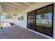 Back patio featuring a sliding glass door, offering views of the green backyard and string lights at 228 E Del Rio Dr, Tempe, AZ 85282