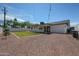 Large backyard with gravel, a patch of grass, and string lights for evening ambiance at 228 E Del Rio Dr, Tempe, AZ 85282