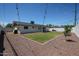 Spacious backyard with gravel and grassy area, surrounded by white block fencing at 228 E Del Rio Dr, Tempe, AZ 85282