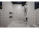Bathroom with white tiling, a bathtub/shower combo, and sleek black shower fixtures at 228 E Del Rio Dr, Tempe, AZ 85282