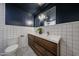 Contemporary bathroom with double sinks, white tiling, a wood vanity and modern fixtures at 228 E Del Rio Dr, Tempe, AZ 85282