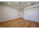 Well-lit bedroom with wood floors, closet and neutral walls at 228 E Del Rio Dr, Tempe, AZ 85282