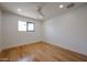 Minimalist bedroom with hardwood floors, a bright window, and neutral walls at 228 E Del Rio Dr, Tempe, AZ 85282