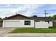 Charming single-story home with a white exterior, attached garage, and well-maintained lawn at 228 E Del Rio Dr, Tempe, AZ 85282