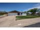 Charming single-story home featuring a well-maintained lawn, attached garage and inviting front patio area at 228 E Del Rio Dr, Tempe, AZ 85282