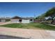 Inviting single-story home with fresh paint, tidy lawn, privacy screen, and an attached one car garage at 228 E Del Rio Dr, Tempe, AZ 85282