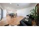Bright living room with hardwood floors, modern furniture, and an open layout to the kitchen at 228 E Del Rio Dr, Tempe, AZ 85282