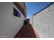 Paver walkway between the home and block fence, leading to a gate at 228 E Del Rio Dr, Tempe, AZ 85282