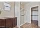 Bright bathroom featuring a glass shower, storage cabinet, and access to a walk-in closet at 22812 N 123Rd Dr, Sun City West, AZ 85375