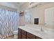 Bathroom with shower/tub combo, dark wood cabinets and an elegant mirror at 22812 N 123Rd Dr, Sun City West, AZ 85375