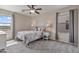 Bedroom with a ceiling fan, neutral walls, and a large window with gray curtains at 22812 N 123Rd Dr, Sun City West, AZ 85375