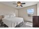 Bedroom featuring a ceiling fan, neutral walls, and window with mountain views at 22812 N 123Rd Dr, Sun City West, AZ 85375