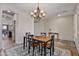 Formal dining room featuring wood table, decorative chandelier, and neutral walls at 22812 N 123Rd Dr, Sun City West, AZ 85375