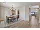 Inviting dining area with a decorative chandelier, neutral wall paint, and hardwood flooring at 22812 N 123Rd Dr, Sun City West, AZ 85375