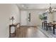 Open-concept entryway and dining area with a sleek console table and bright, natural light at 22812 N 123Rd Dr, Sun City West, AZ 85375
