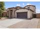 Attractive home with a spacious driveway and a two-car garage and lush landscaping at 22812 N 123Rd Dr, Sun City West, AZ 85375