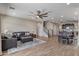 Spacious living room with a ceiling fan, wood floors, and comfortable furniture at 22812 N 123Rd Dr, Sun City West, AZ 85375