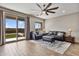 Inviting living room featuring wood floors, comfortable seating, and a sliding glass door to the backyard at 22812 N 123Rd Dr, Sun City West, AZ 85375
