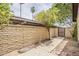 Enclosed backyard featuring a block wall, gated access, and mature trees for added privacy at 2515 S Maple Ave # 103, Tempe, AZ 85282