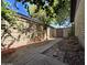 View of the backyard with block wall, walkway, desert landscaping, and a metal gate at 2515 S Maple Ave # 103, Tempe, AZ 85282