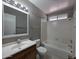 Standard bathroom with tub/shower, gray walls, and a wooden vanity at 2515 S Maple Ave # 103, Tempe, AZ 85282