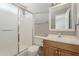 Bathroom featuring a walk-in shower with glass door and wood vanity at 2515 S Maple Ave # 103, Tempe, AZ 85282