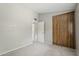 Bedroom with neutral carpet and a large closet with wood sliding doors at 2515 S Maple Ave # 103, Tempe, AZ 85282