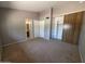 A spacious bedroom with plush carpet, organized closet, and an adjacent bathroom at 2515 S Maple Ave # 103, Tempe, AZ 85282
