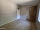 Cozy bedroom featuring plush carpet, neutral wall color, natural light, and closet space at 2515 S Maple Ave # 103, Tempe, AZ 85282