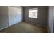 Standard bedroom with window, closet, neutral walls, and plush carpeting at 2515 S Maple Ave # 103, Tempe, AZ 85282