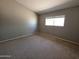 Neutral bedroom featuring plush carpet, a window for natural light, and a calming color palette at 2515 S Maple Ave # 103, Tempe, AZ 85282
